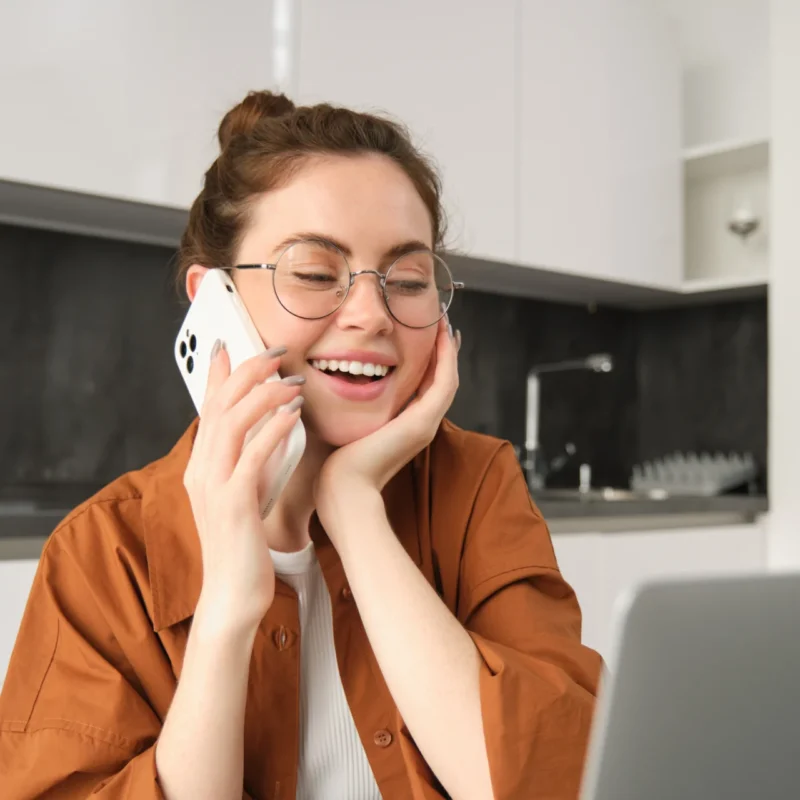 portrait beautiful young woman managing her own business from home freelancer making phone call
