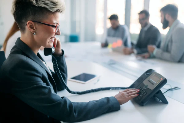 woman calling a 0300 number on landline