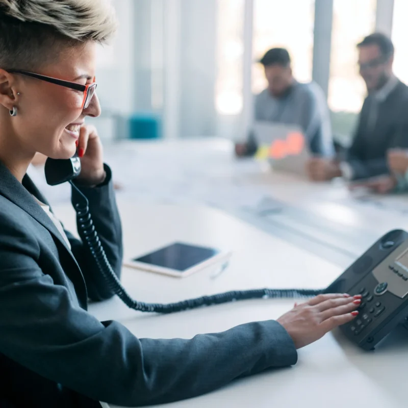 woman calling a 0300 number on landline