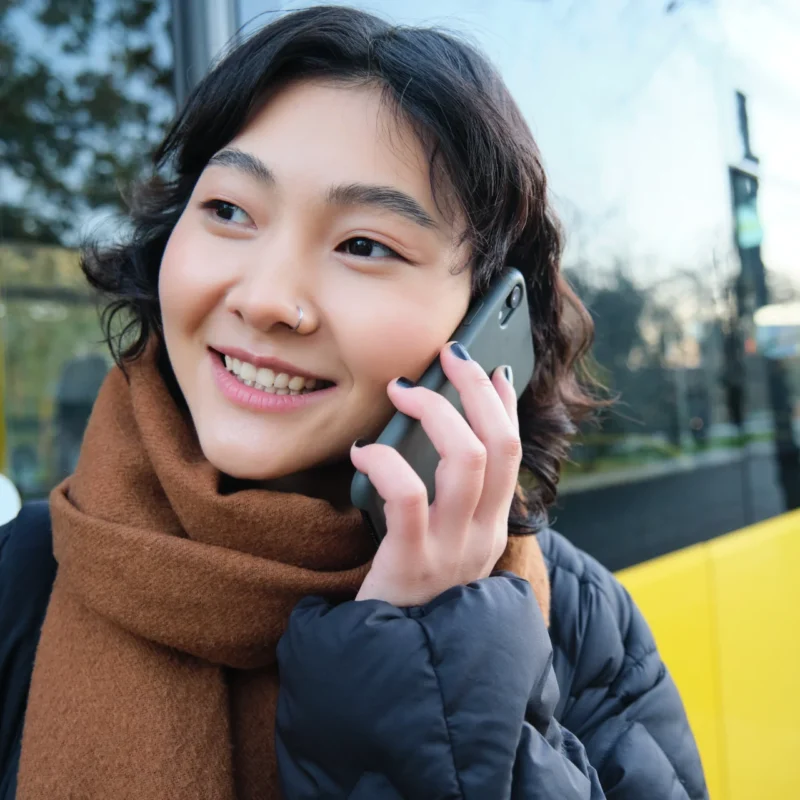 a woman calling an 0800 number in her phone