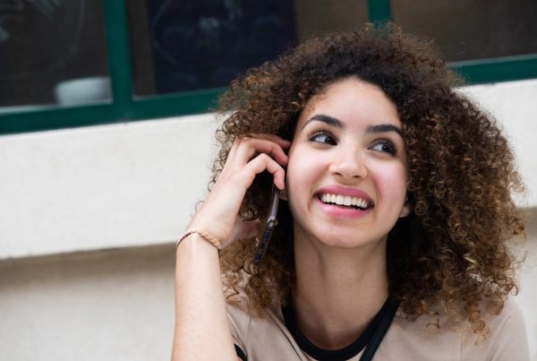 Close-up of a beautiful young woman talking on the phone. Calling an 0300 number on EE.