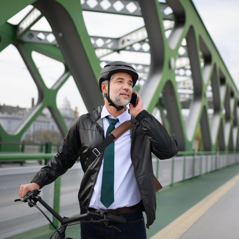 portrait of businessman commuter on the way to work while calling a 0300 number on Three Mobile