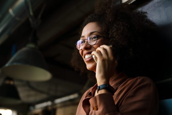 young woman smiling while talking on cellphone