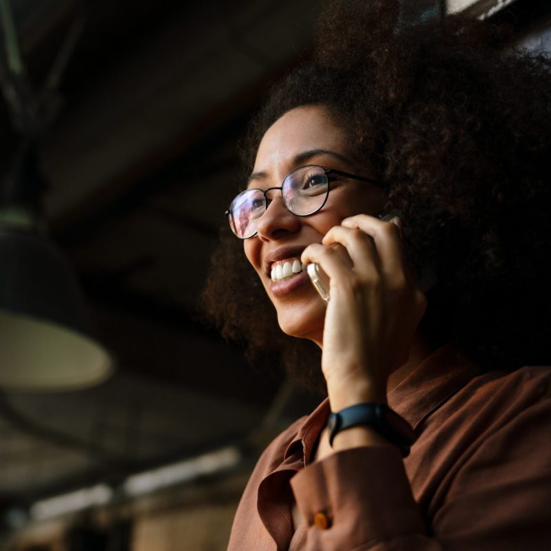 young woman smiling while talking on cellphone